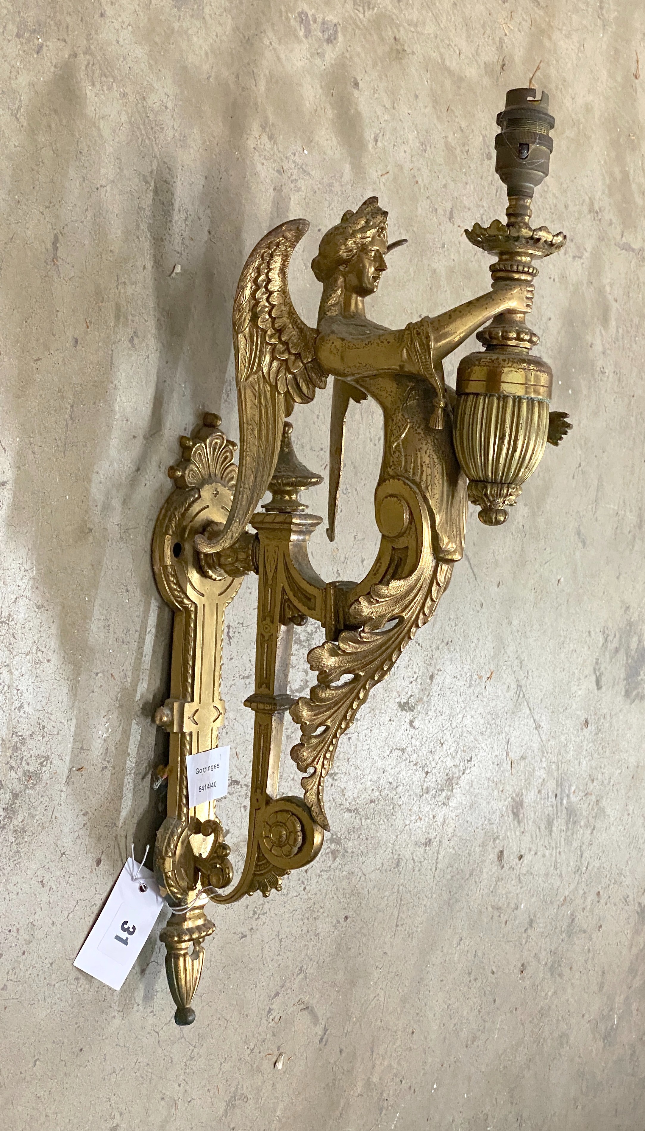 A brass single caryatid wall light, height 50cm